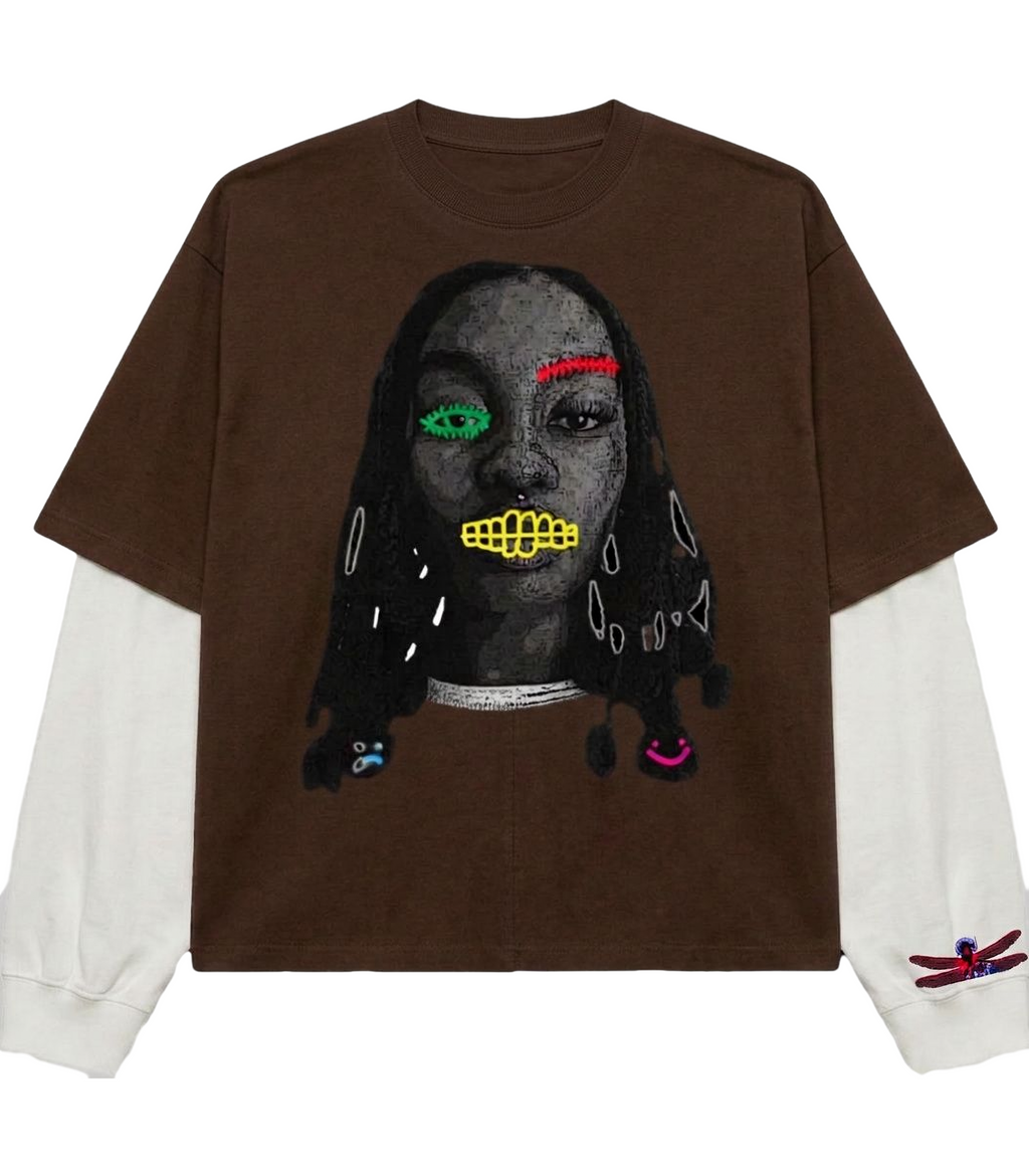 Brown t-shirt with a graphic design of a face on a white background